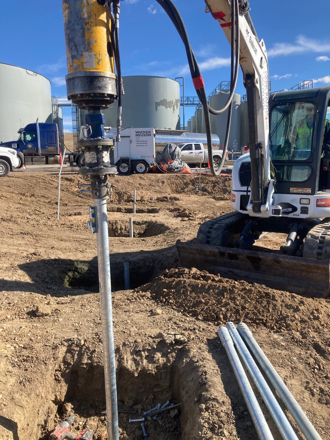 Park Range excavator installing an ECP helical pile for the deicing facility at Denver International Airport