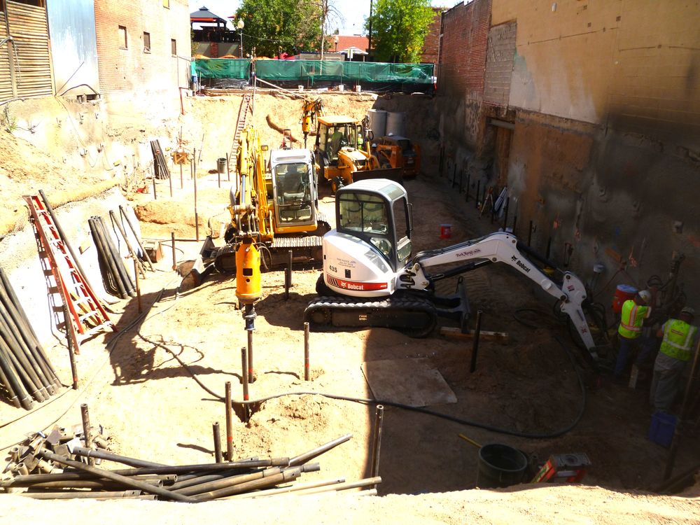 Park Range crews installing helical piles in a downtown excavation for Izakaya Den